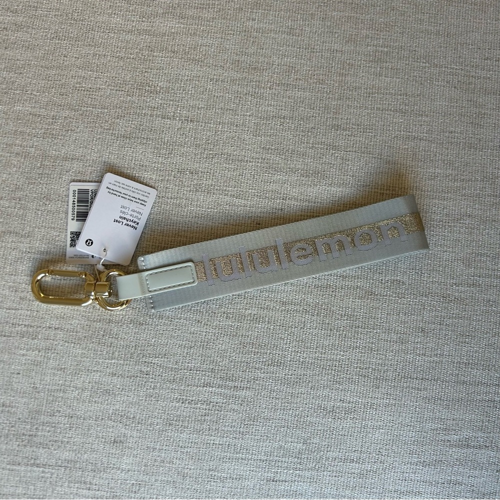 NWT lululemon athletica Gray and Gold Never Lost Keychain
